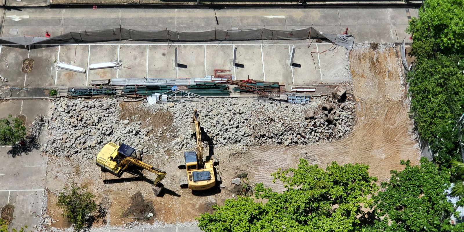 Excavators working on a construction site seen from above