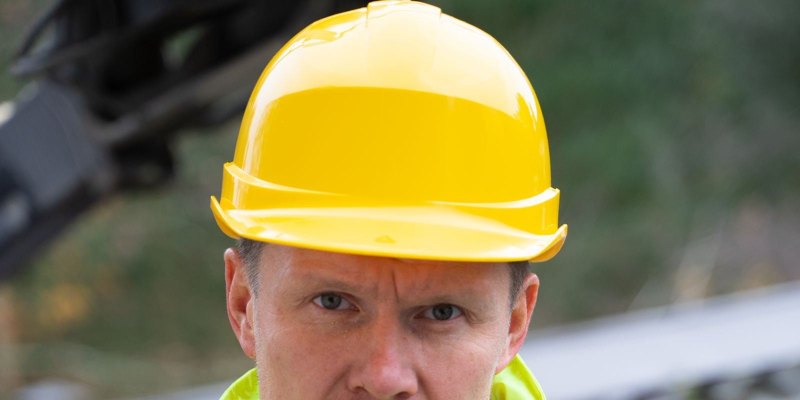 Tradie in hi-vis jacket and yellow hard hat