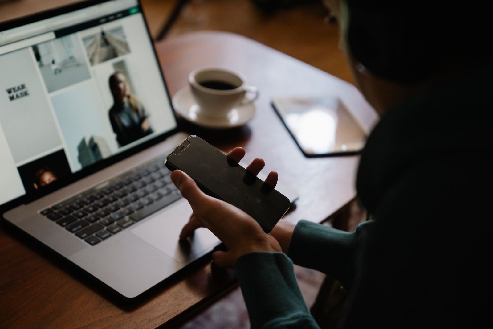 Man using a laptop and smartphone at work